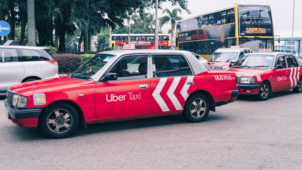 Red Uber Taxi on Busy Urban Street