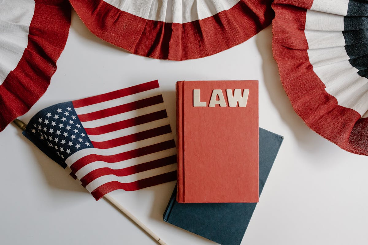 American flag with a law book, symbolizing independence and politics.