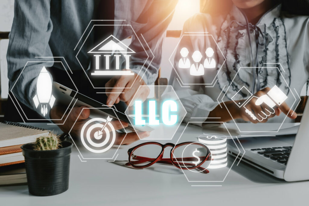 Limited Liability Company (LLC) Business Concept, Business team analyzing data and using tablet on desk with limited liability company icon on Vr screen.